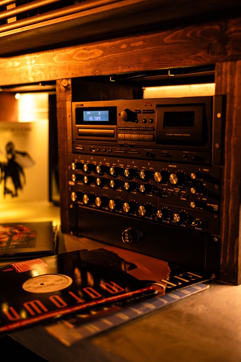 The hi-fi rack and mixer above a stack of records at Kasai Records.