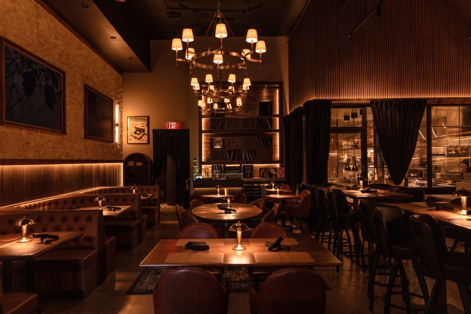 The dining room at Kasai Records — booths, brass chandeliers and the record wall before service.