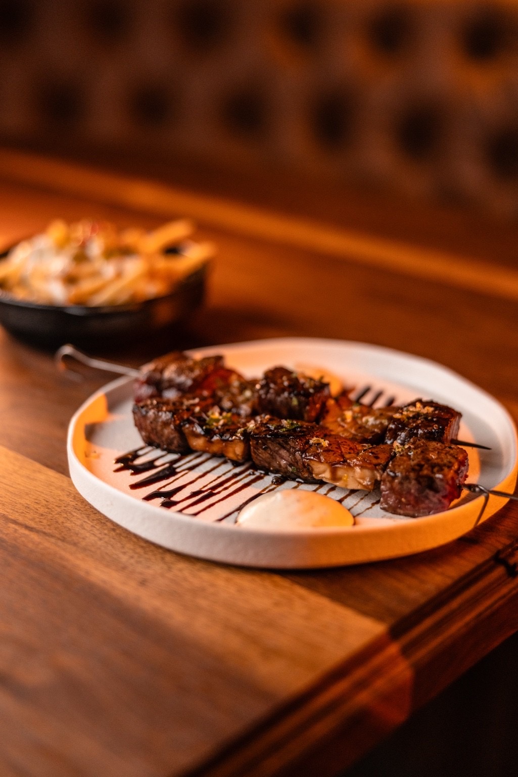 Grilled skewers plated with a side of fries at Kasai Records.
